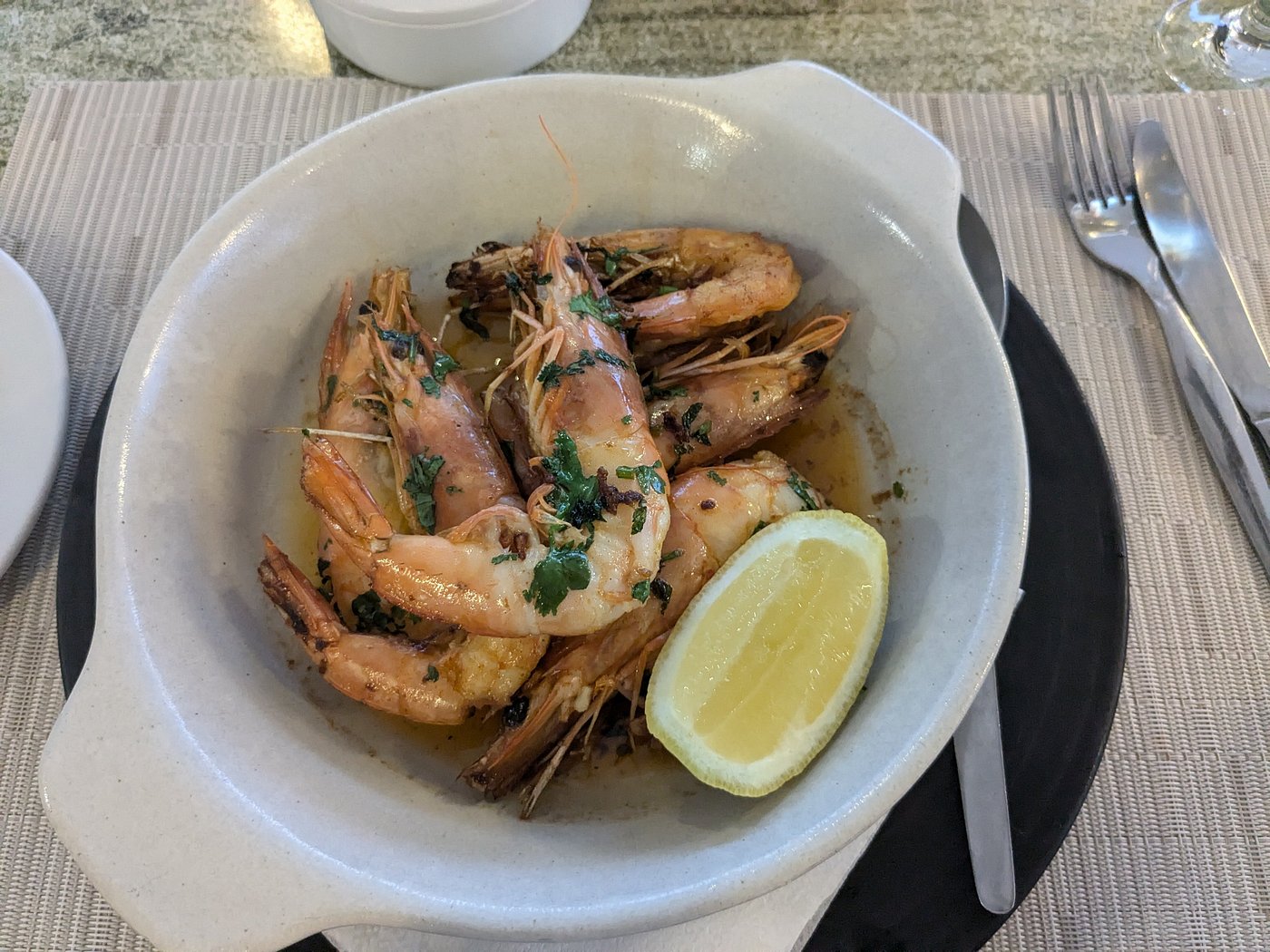 Louisiana garlic prawns in a clay dish